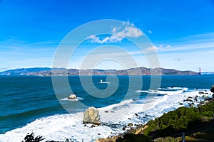 The view of golden gate bridge in Lands end at San Francisco- San Francisco. summer , cloud , rock , sea, plant.