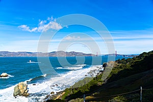 The view of golden gate bridge in Lands end at San Francisco- San Francisco. summer , cloud , rock , sea, plant.