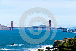 The view of golden gate bridge in Lands end at San Francisco- San Francisco. summer , cloud , rock , sea, plant.