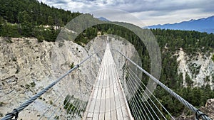 View of Golden Skybridge with a green cliff in the background. Golden, BC, Canada.