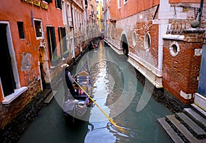 A view of Gondolas and Gondolier on a narrow Venice Canal, Venice, Italy