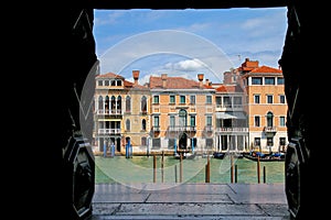 View of Grand Canal framed by a building window in Venice, Italy