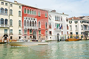 A view of a Grand Canal, old houses, motorboats in Venice, Italy