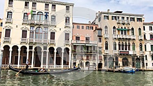 A view of a Grand Canal, old houses, motorboats in Venice, Italy