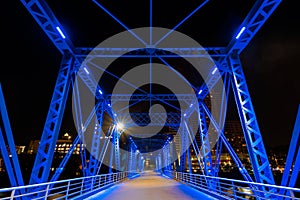 View of the Grand Rapids blue bridge from the river at night - Michigan