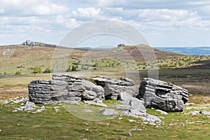 View of the granite bedrock outcrops at Top Tor, Dartmoor National Park, Devon, UK, on a bright cloudy day