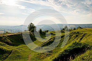 A view of the grassy remains of old quarries on Rodborough Common, Stroud, at dusk