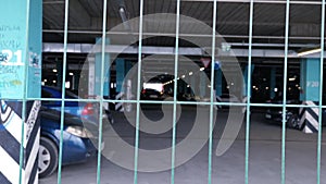 View through the grates to the parking lot with cars under the shopping