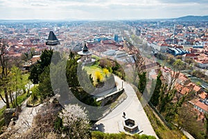 View at Graz City from Schlossberg hill, City rooftops, Mur river and city center, clock tower.