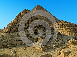 A view of the Great Pyramid at Giza, Egypt with small burial step pyramids in the foreground