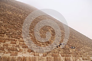 View of the Great Pyramid from an interesting perspective on a foggy morning in Giza, Cairo