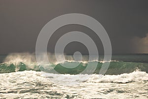 View of great storm on the sea. Strong wind and big waves with splash drops under dark sky. Alanya, Turkey