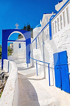 A view of a Greek church with iconic blue and white stairs again