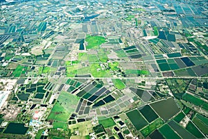 The view of green field and farm and city downtown in middle of Thailand. It shot from Jetplane photo