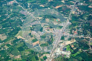 The view of green field and farm and city downtown in middle of Thailand. It shot from Jetplane photo