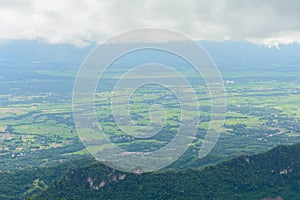 View of the green land from mountain in cloudy day