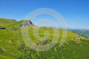 View on a green plateau and Caucasian ridge