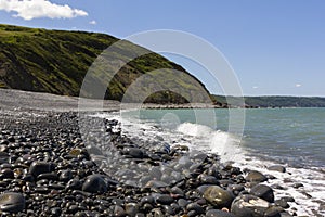 View of Greencliff Beach at High Tide, Looking South West towards Bucks Mills, Devon, UK.