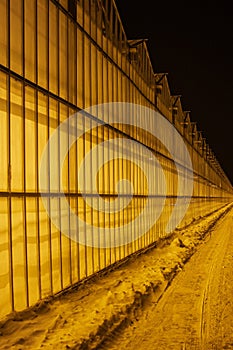 view of the greenhouse from the outside, all shining against the backdrop of snow and frosty night, providing strategic supplies