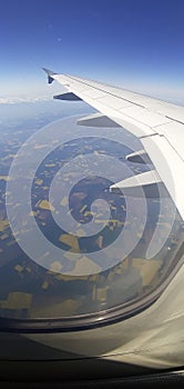 View of the ground and the sky from a airplane .