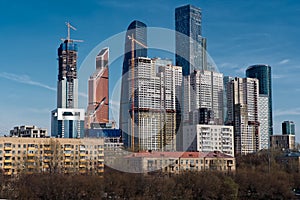 View on group of modern high-rise buildings and old last century buildings in the foreground.