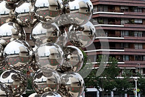 View of the Guggenheim Bilbao, reflected in Anish Kapoor's Tall Tree And The Eye sculpture