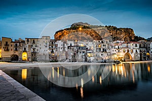 View on habour and old houses in Cefalu at night, Sicily