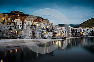 View on habour and old houses in Cefalu at night, Sicily