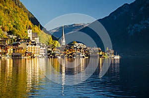 View of Hallstatt Hallstadt town with reflection in lake with blue sky above, Austria