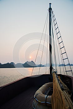 View of Halong bay from a sailboat during sunset. Safety boat on the floor. Vietnam