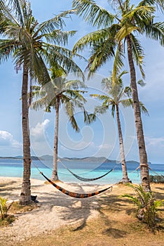 View of hammocks on tropical beach on the Banana island photo