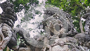View of hand carved grey stone sculpture of spiritual, religious animal creature