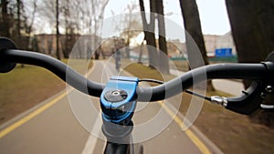 View from handle bar while driving. Driving bicycle on asphalted park road