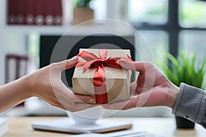 view of hands Giving a business gift in an office, corporate party celebration concept