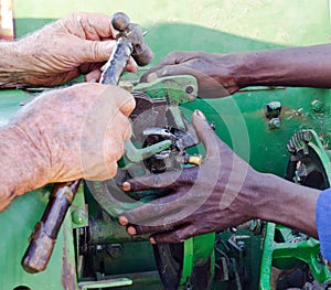 View of hands repairing old bailer photo