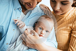 View of happy husband and wife holding little child