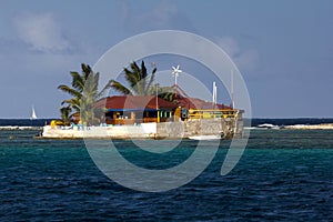 View of Happy Island, a Tiny Brightly Coloured Island Restaurant with Palm Trees; the Grenadines, Eastern Caribbean.