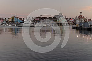 View of a harbor with boats and ships in the evening