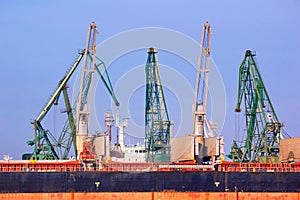 View of the harbor cranes and cargo ships in the seaport of Varna