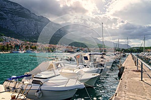 View of the harbor and old town, Makarska, Dalmatia, Croatia. Travel background with yachts, sea, architecture and rocks