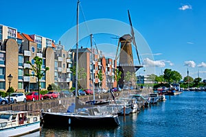 View of the harbour of Delfshaven and the old grain mill De Destilleerketel. Rotterdam, Netherlands