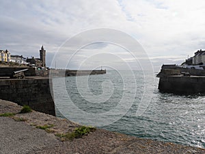 View of harbour with old ship cannon in Porthleven Cornwall England