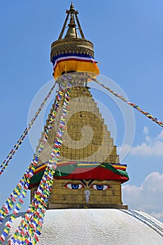 View of the harmika square tower and spire mounted on the dome of Boudhanath, with stylized Eyes of Buddha or Adamantine View