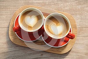 view Heart shaped saucer complements two cups of steaming coffee perfectly