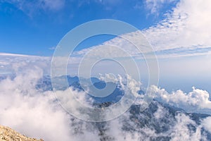 View from a height of 2600 meters to the tops of the Tauride mountains, covered with clouds, haze