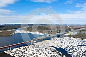 View from the height of the bridge over the river Nadym during the ice drift in Northern Siberia