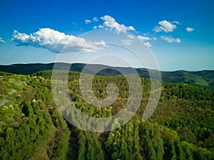 A view from a height of the meadows and slopes of the Balkan Mountains under daylight in Bulgaria