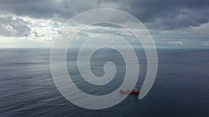 View from the height on a sea vessel for transportation of a dry-cargo ship with a closed hold is anchored near the