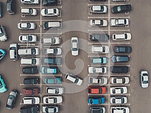 A view from a height to the parking lot. The process of parking. Searching for space in a busy car park. Parking maneuvers. Park