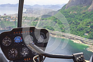 View from a helicopter cockpit flying over Rio de Janeiro. Cockpit with instruments panel. Captain in the aircraft cockpit. photo